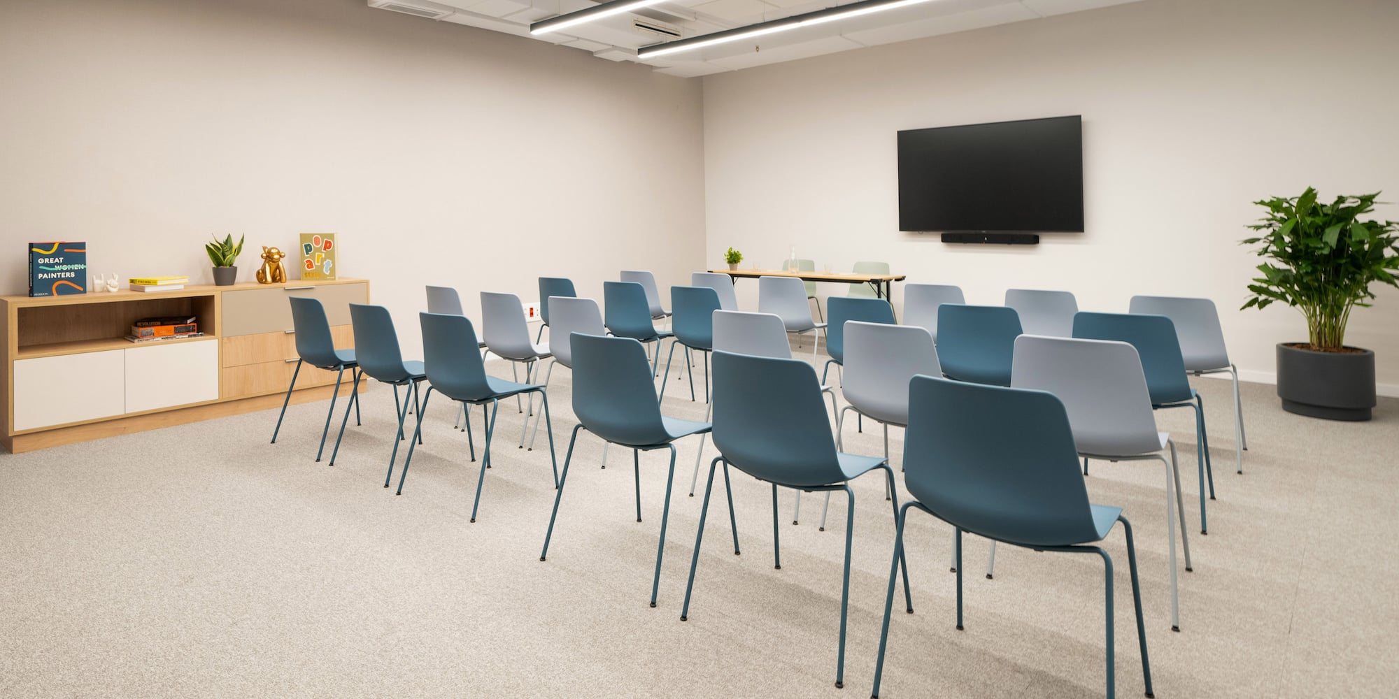 a room with many chairs and a television