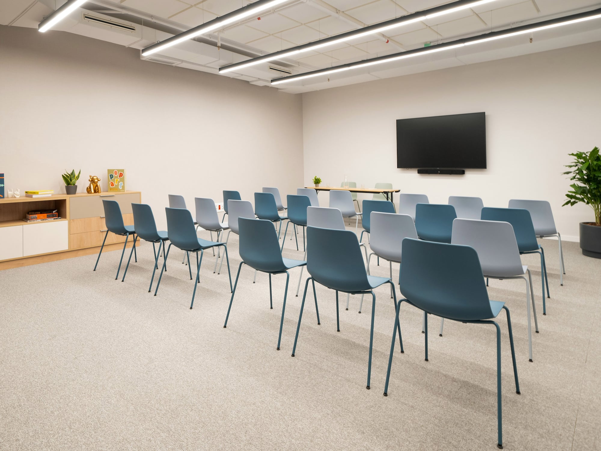 a room with many chairs and a television