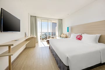 a room with a bed and a television