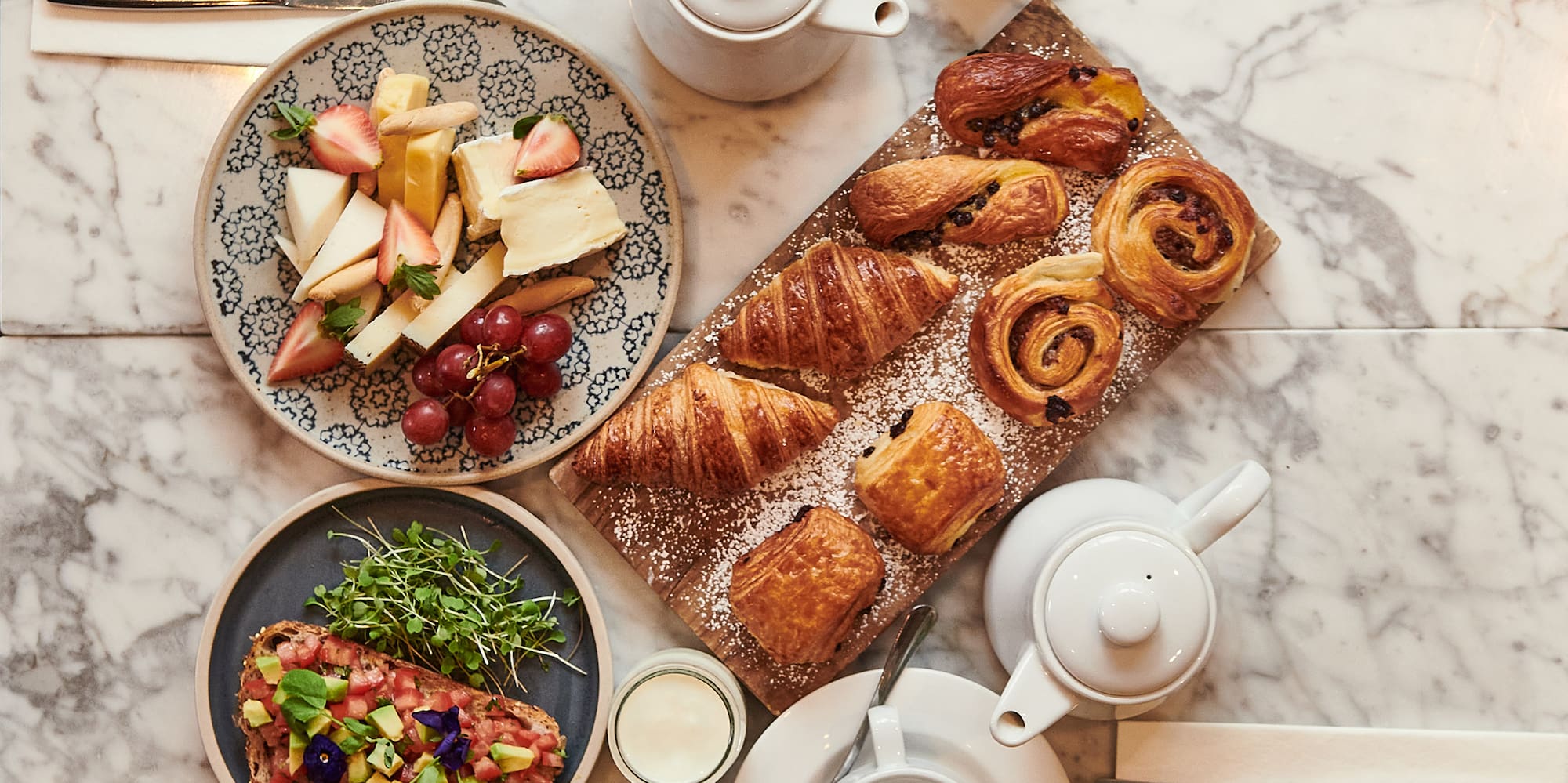 a table with plates of food and utensils