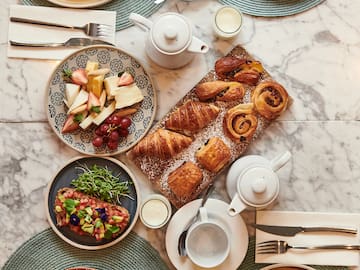 a table with plates of food and utensils