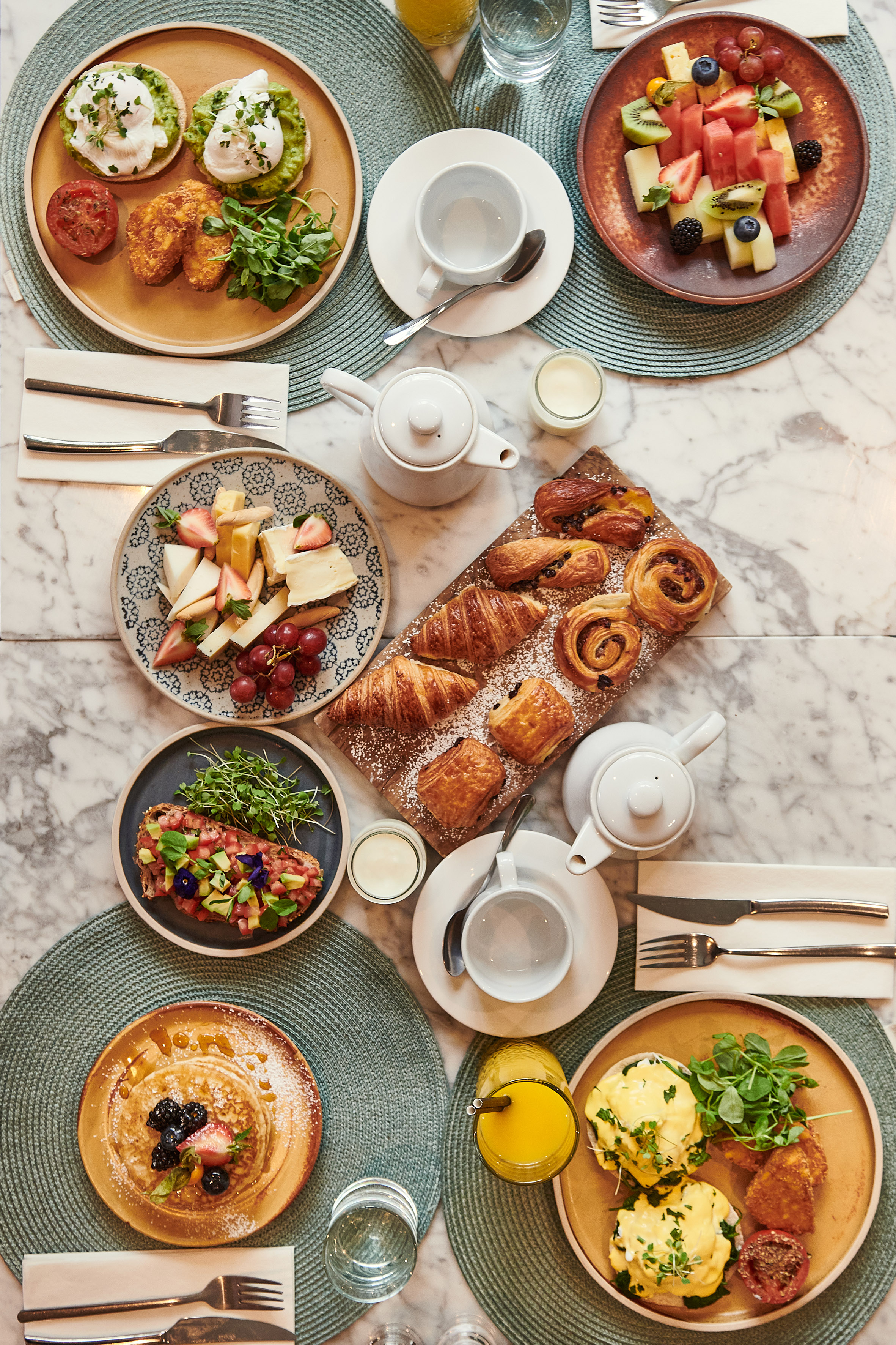 a table with plates of food and utensils