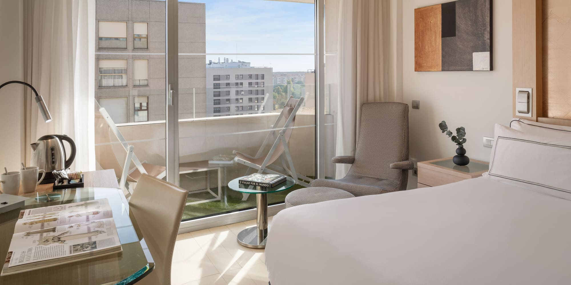 a bedroom with a glass door and a bed