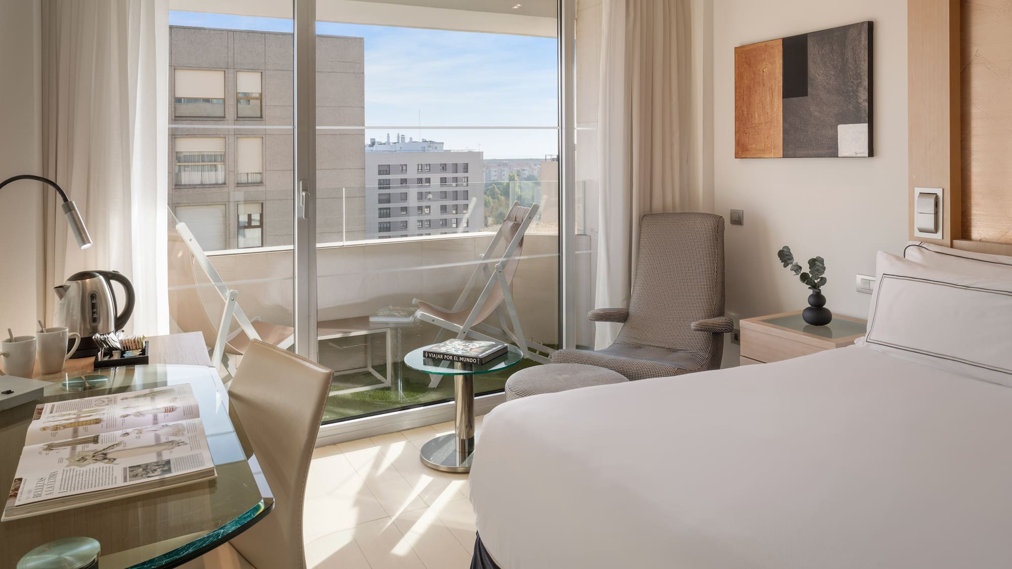 a bedroom with a glass door and a bed