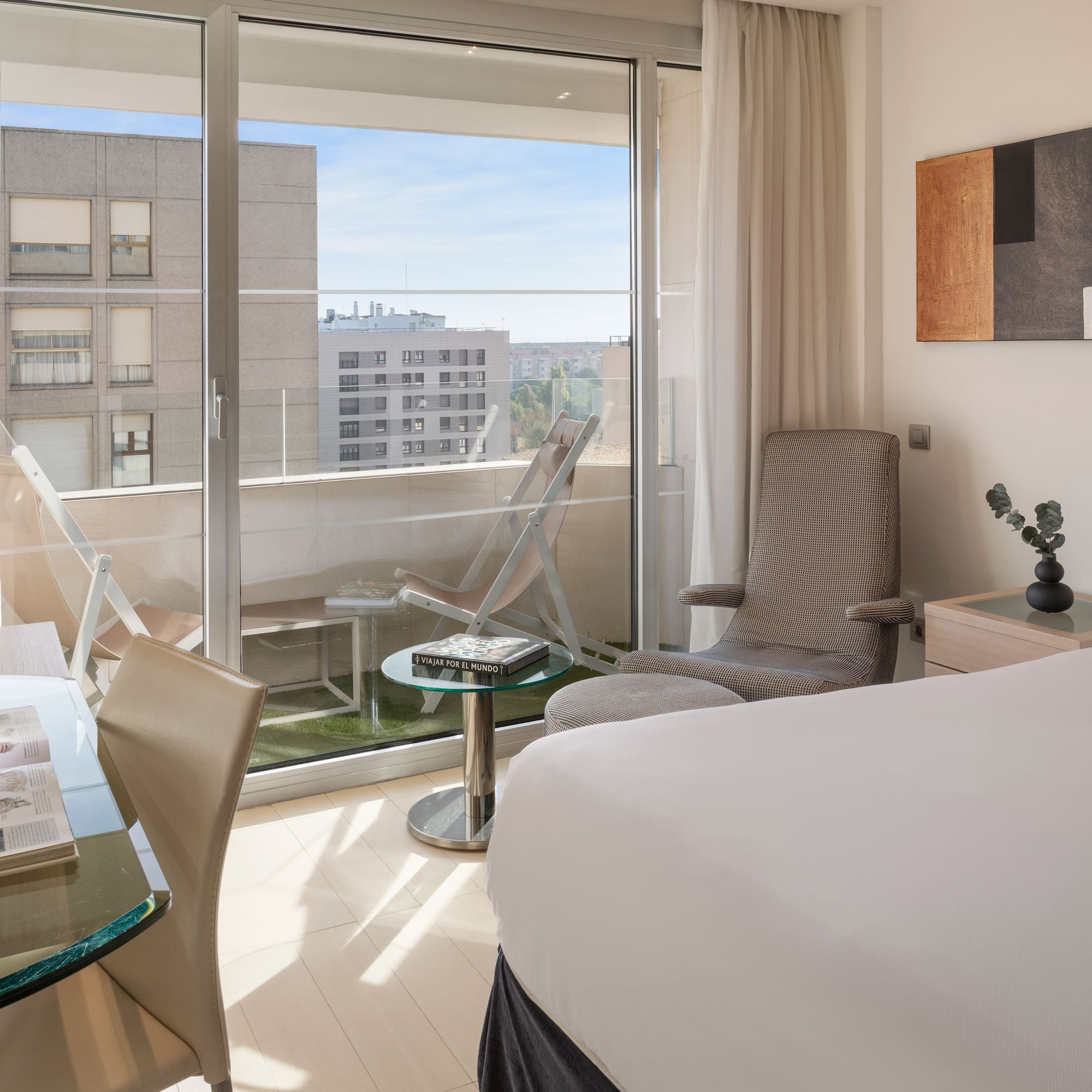 a bedroom with a glass door and a bed