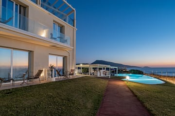 a building with a pool and a lawn