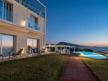 a building with a pool and a lawn