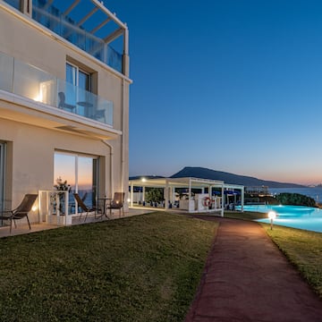 a building with a pool and a lawn