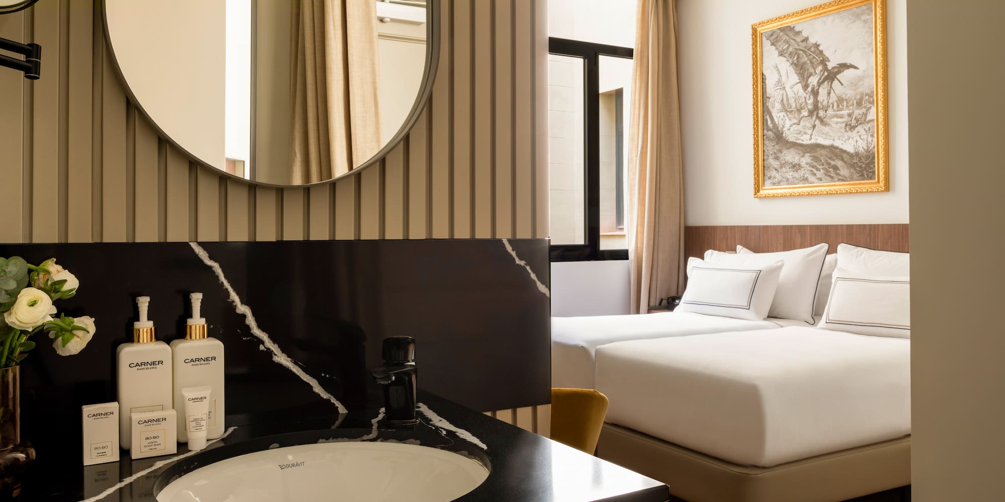 a bathroom with a mirror and a bed