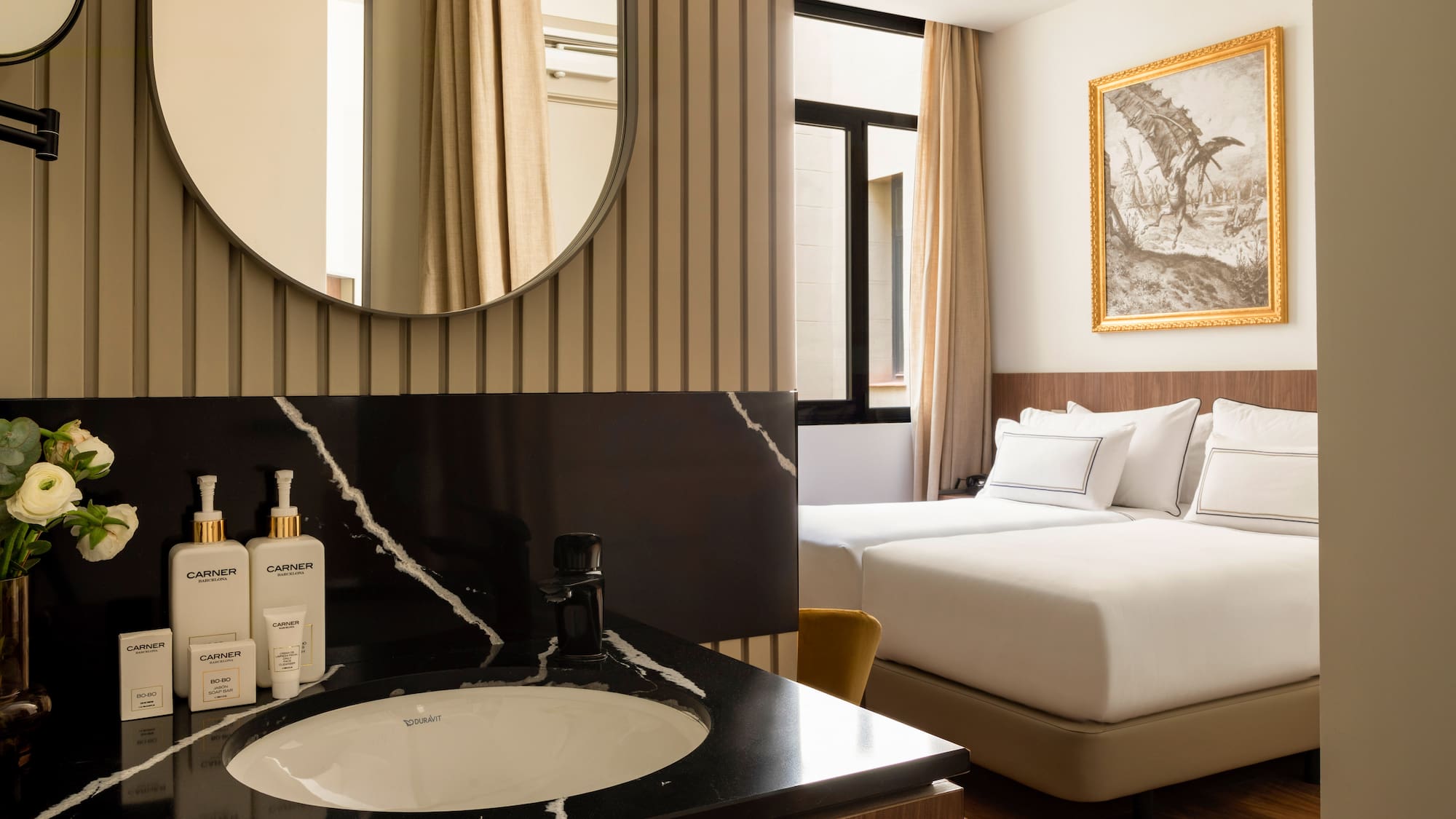 a bathroom with a mirror and a bed