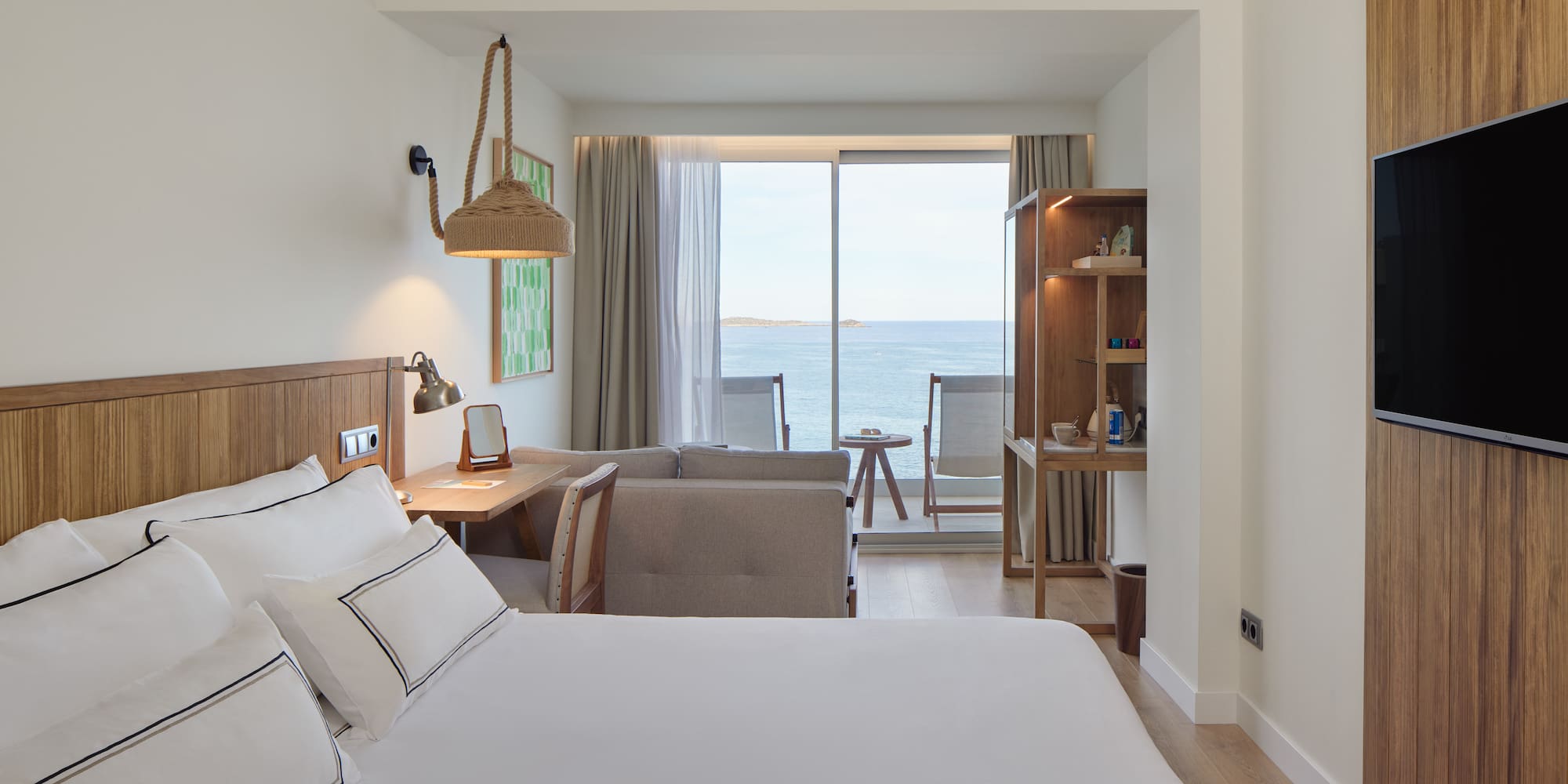 a room with a bed and a table and chairs