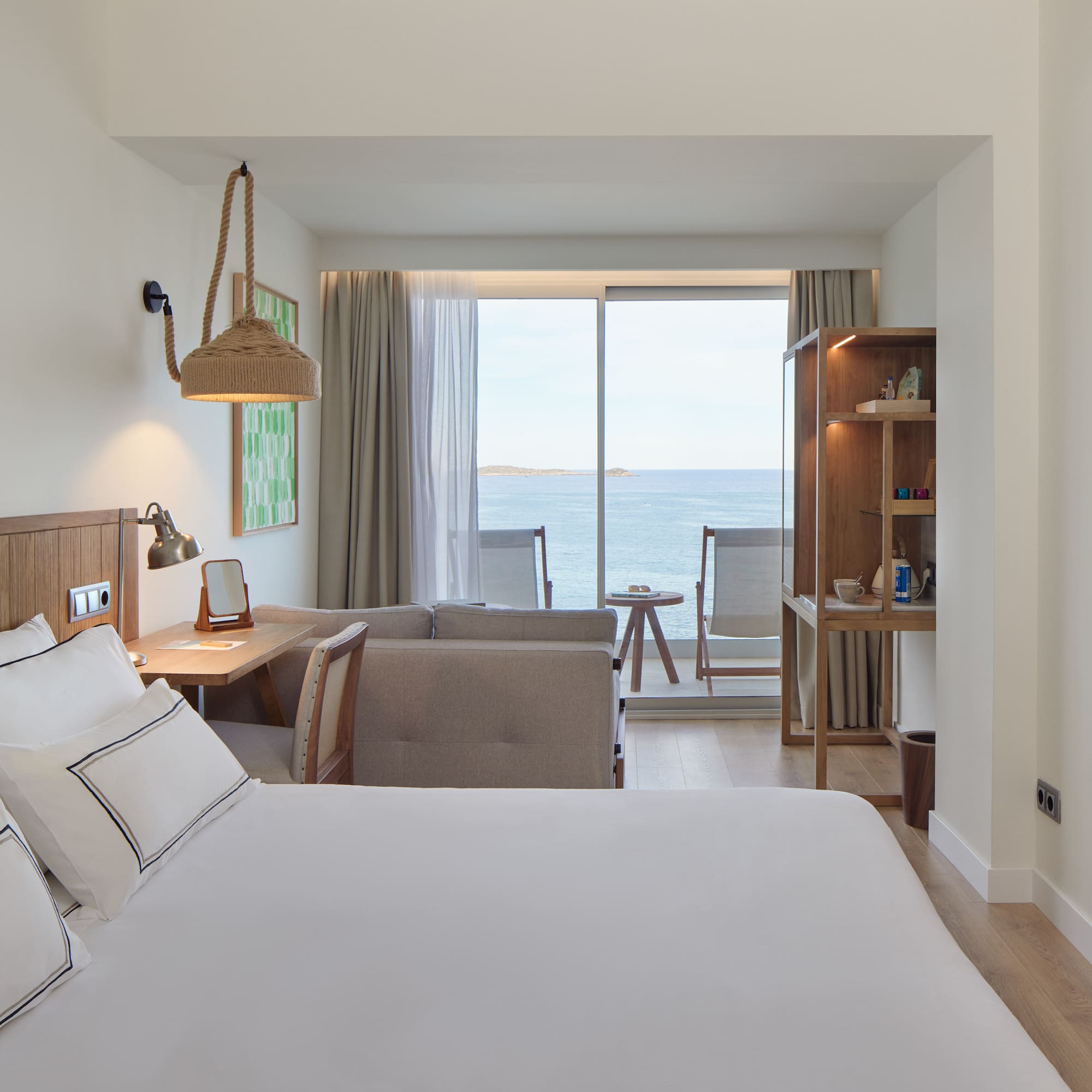 a room with a bed and a table and chairs