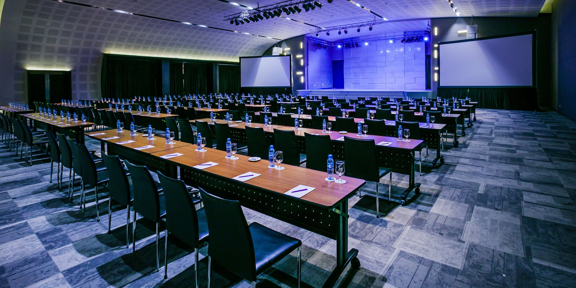 a large conference room with tables and chairs