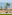 Beach resort terrace with lounge seating, palm trees, and ocean view.