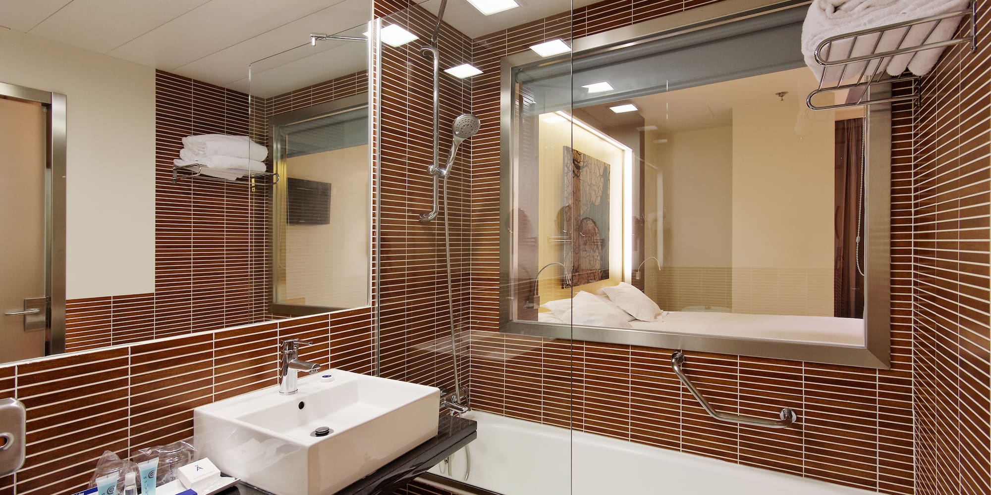 a bathroom with a glass shower and sink