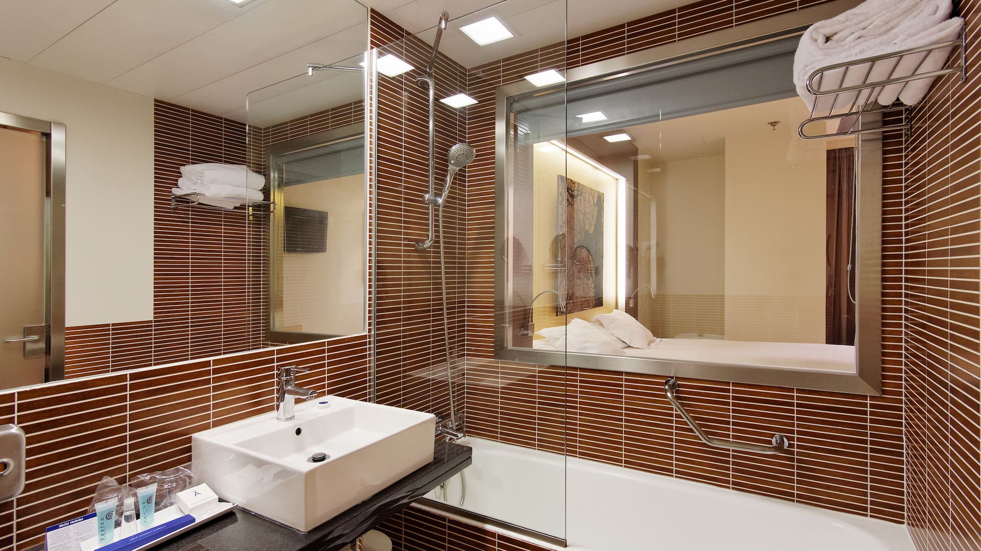 a bathroom with a glass shower and sink