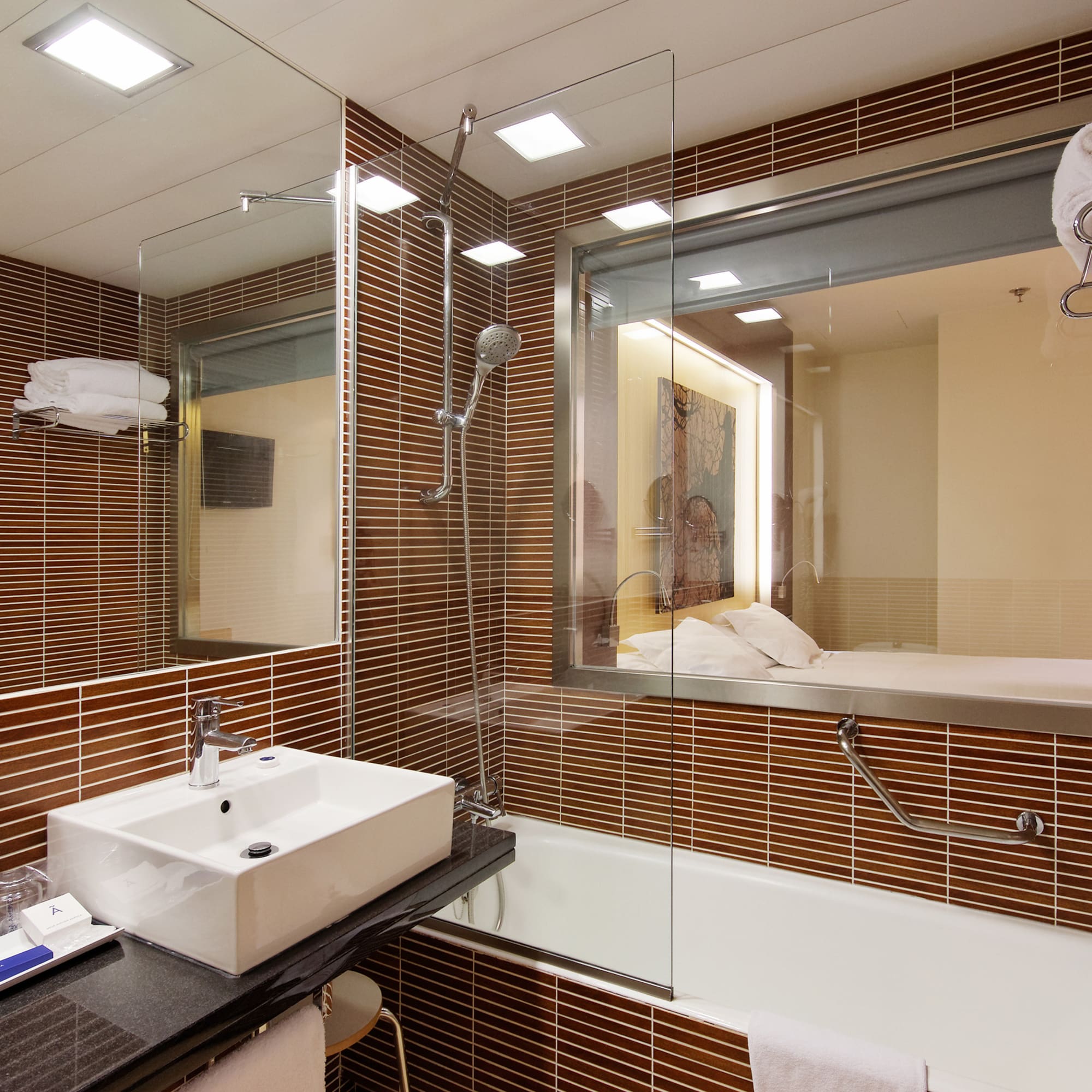 a bathroom with a glass shower and sink