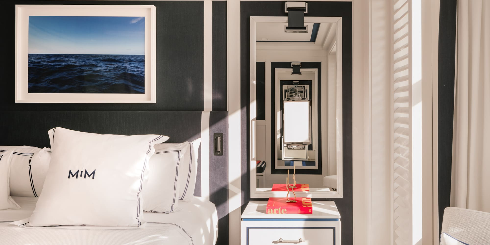 a mirror next to a bed