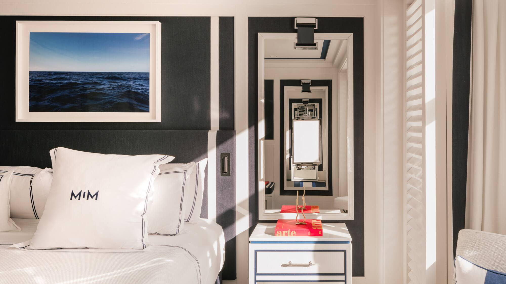 a mirror next to a bed