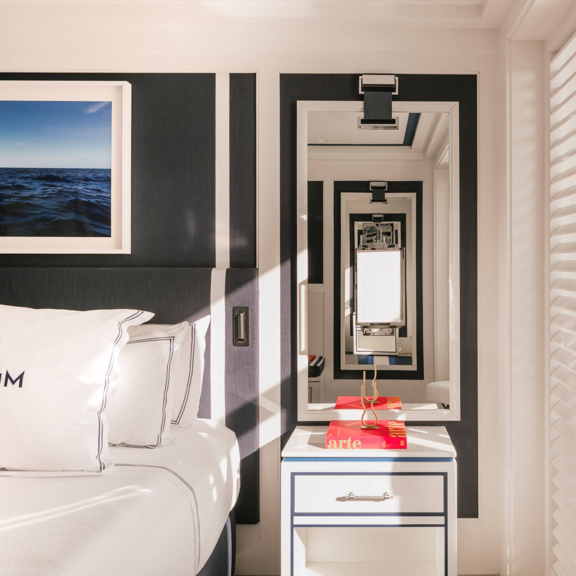 a mirror next to a bed