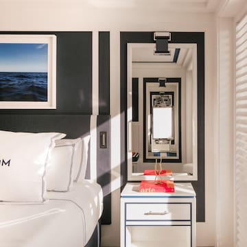 a mirror next to a bed