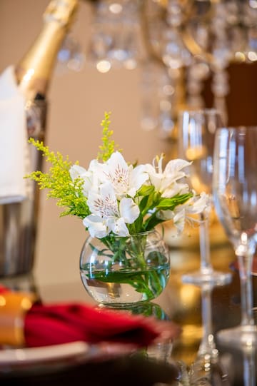 a glass vase with flowers on a table