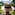 Person's back with straw hat, overlooking green tropical landscape.