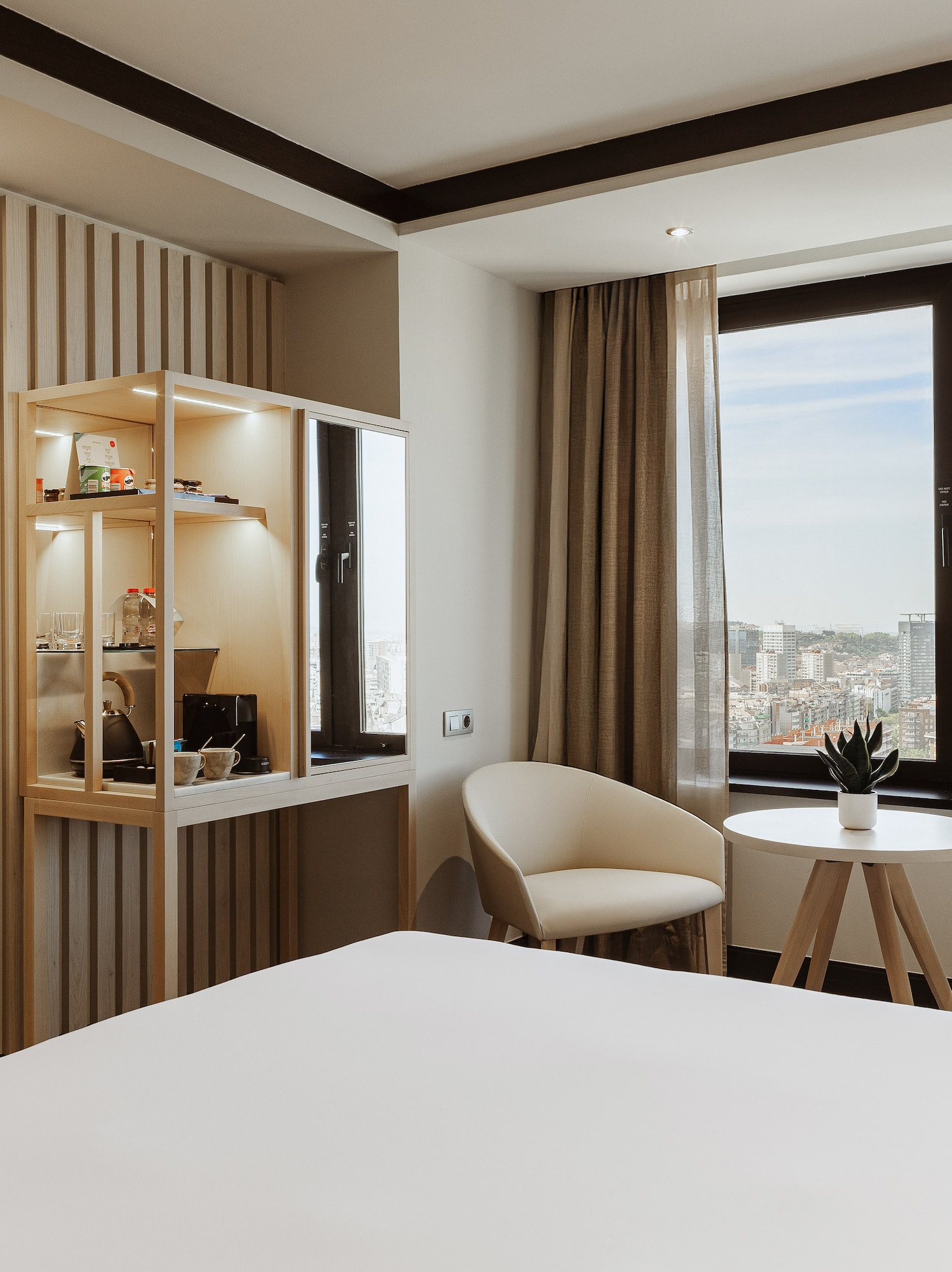 a room with a bed and chairs and a table