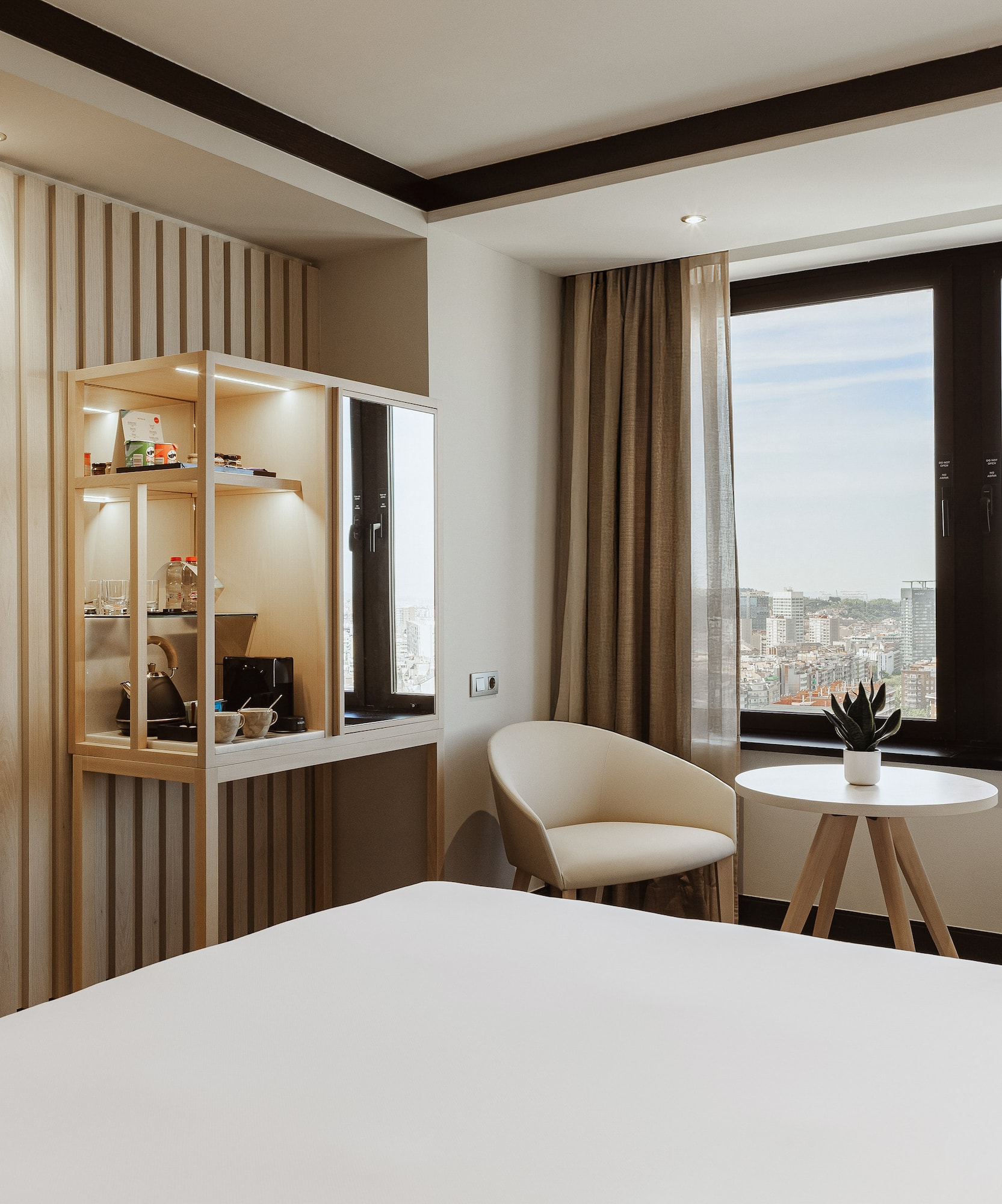 a room with a bed and chairs and a table