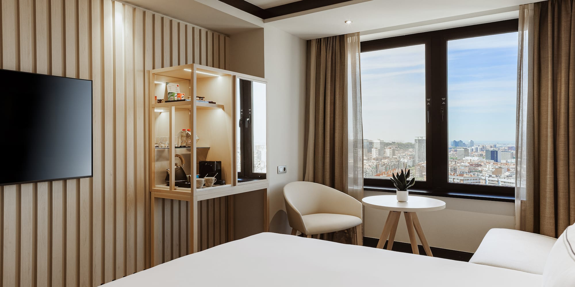 a room with a bed and chairs and a table