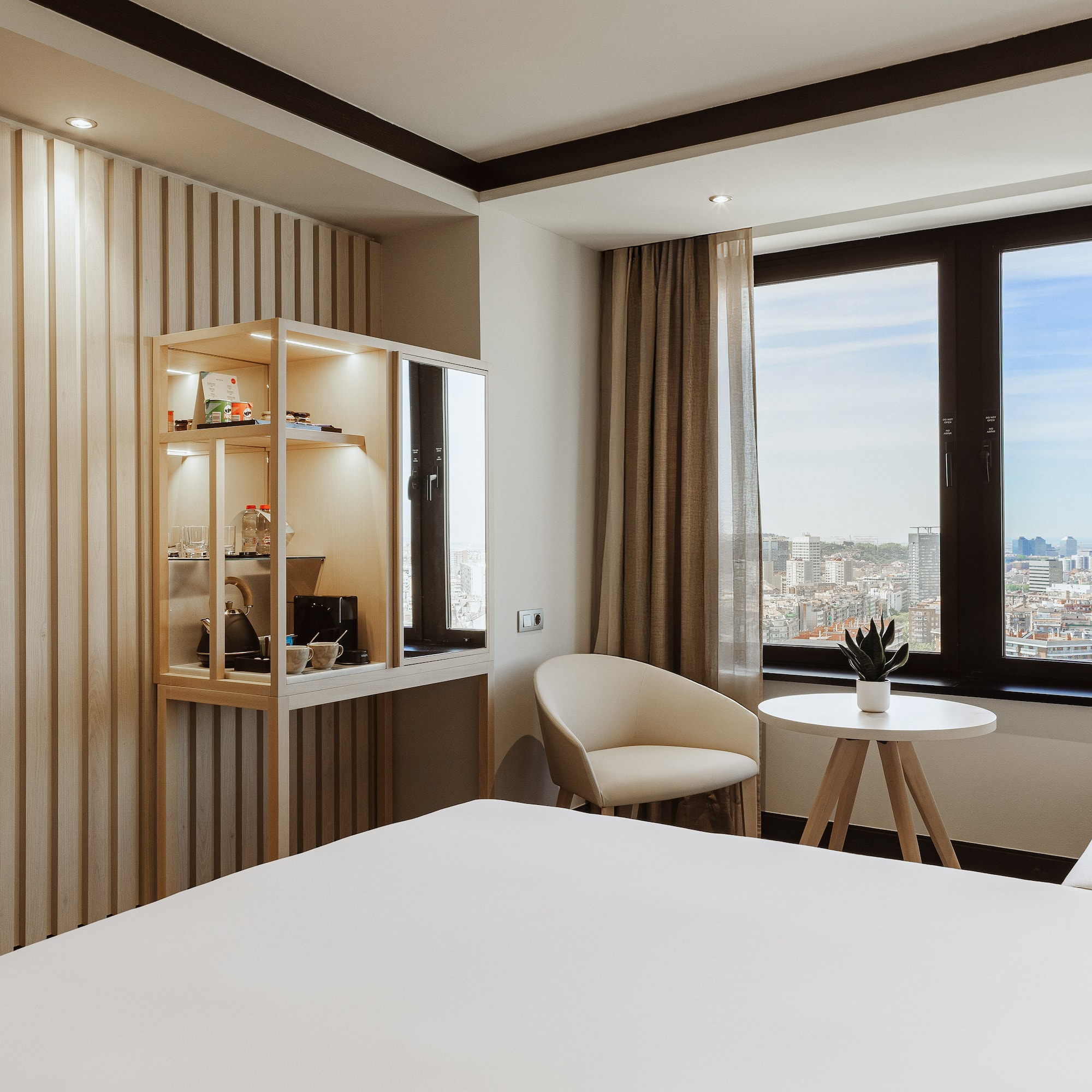 a room with a bed and chairs and a table