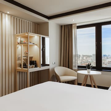 a room with a bed and chairs and a table