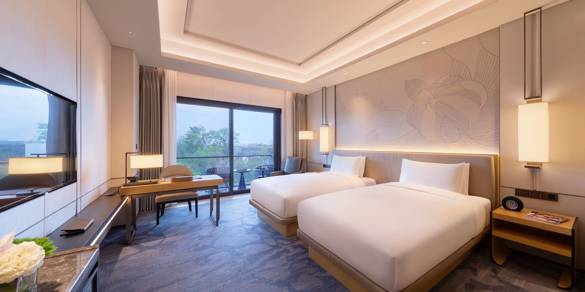 a room with two beds and a desk