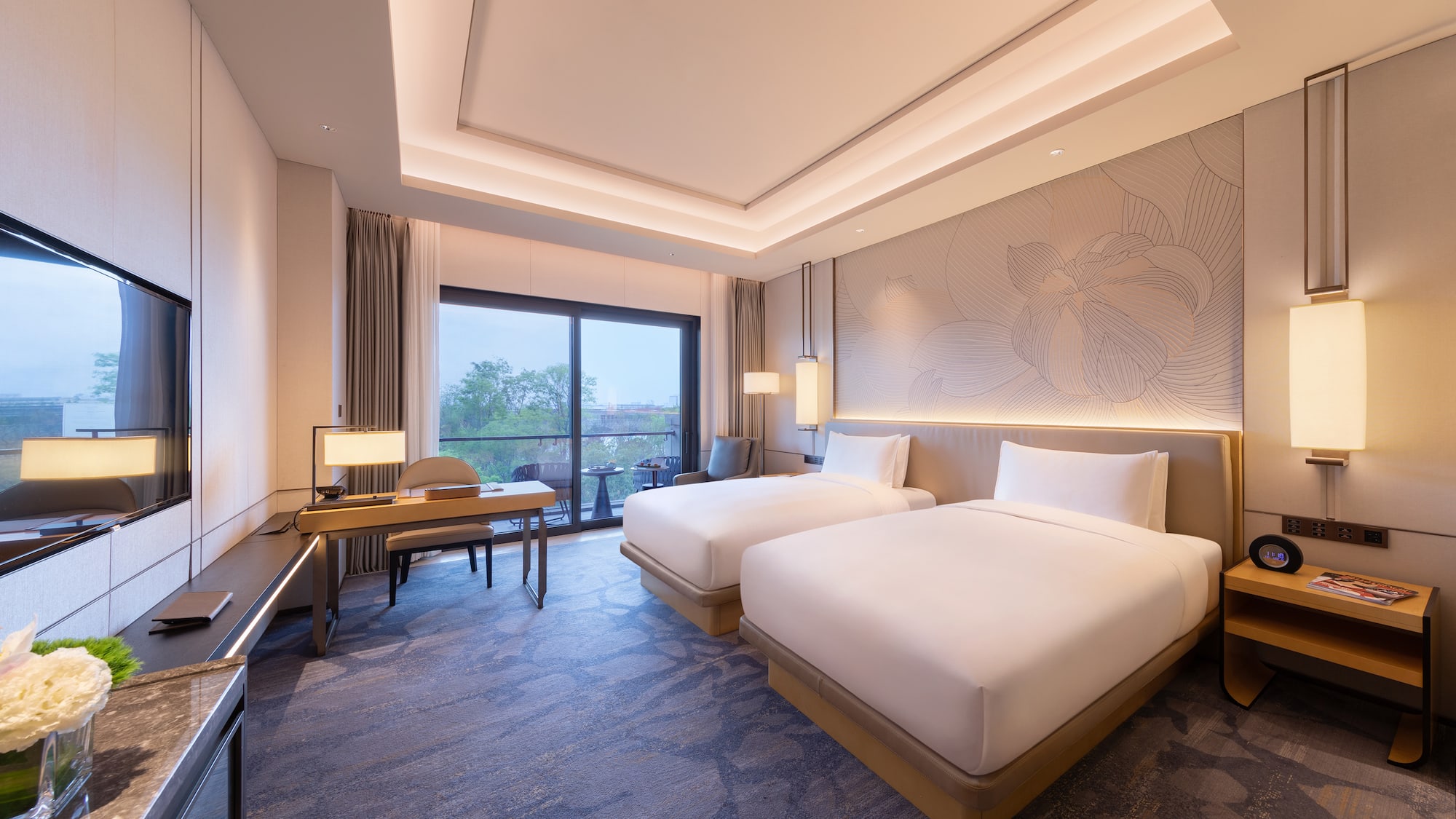 a room with two beds and a desk