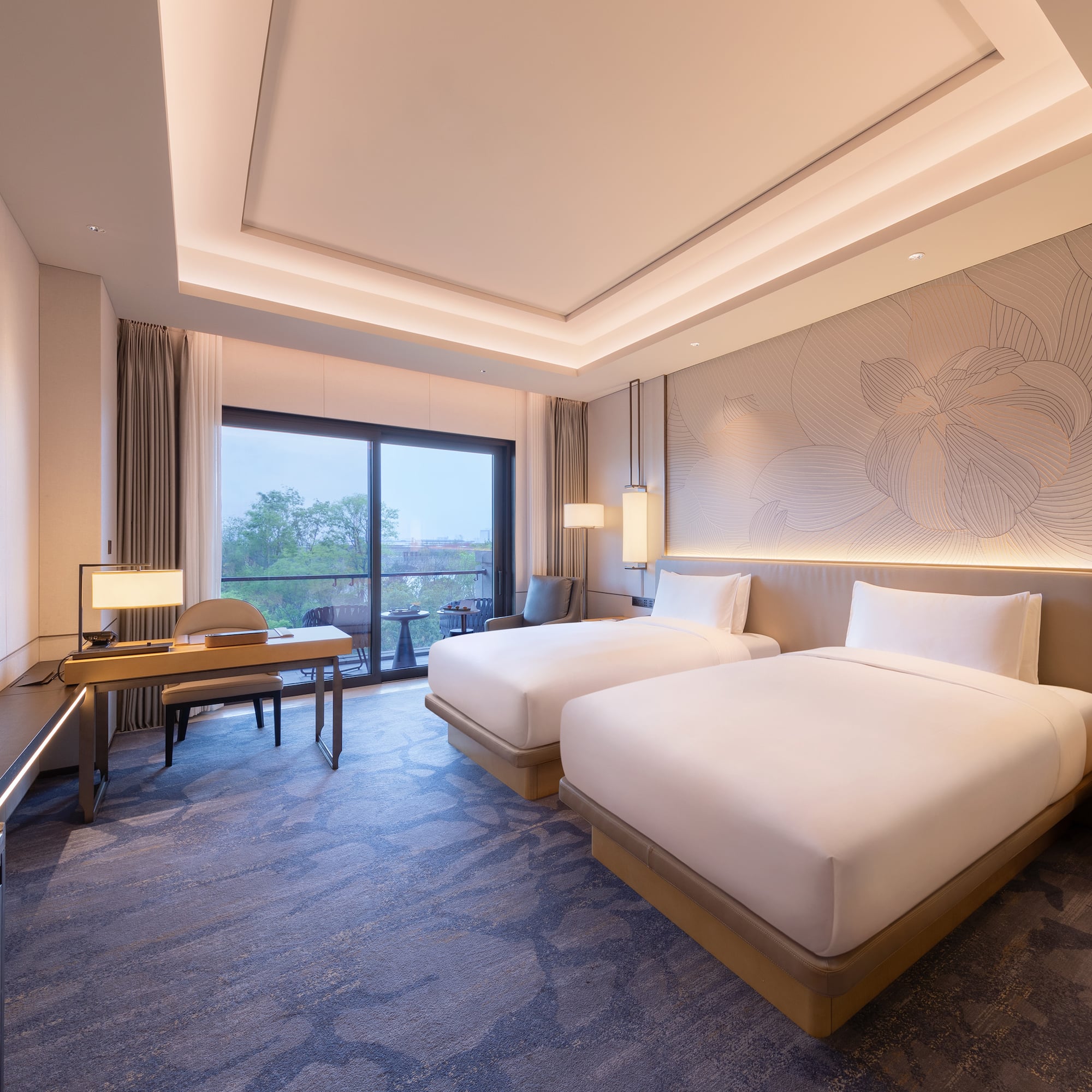 a room with two beds and a desk