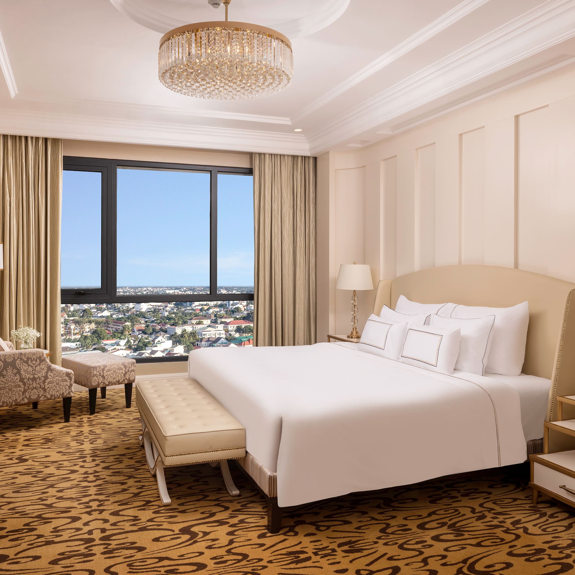 a bedroom with a large bed and a chandelier