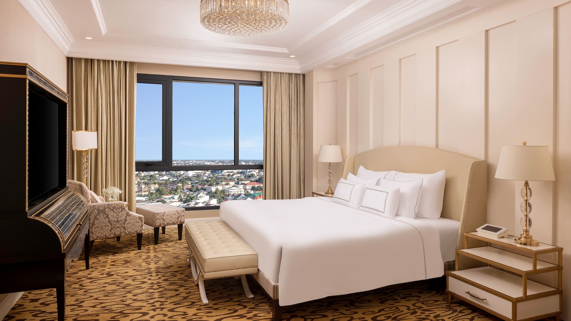 a bedroom with a large bed and a chandelier