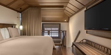 a room with a bed and a bench