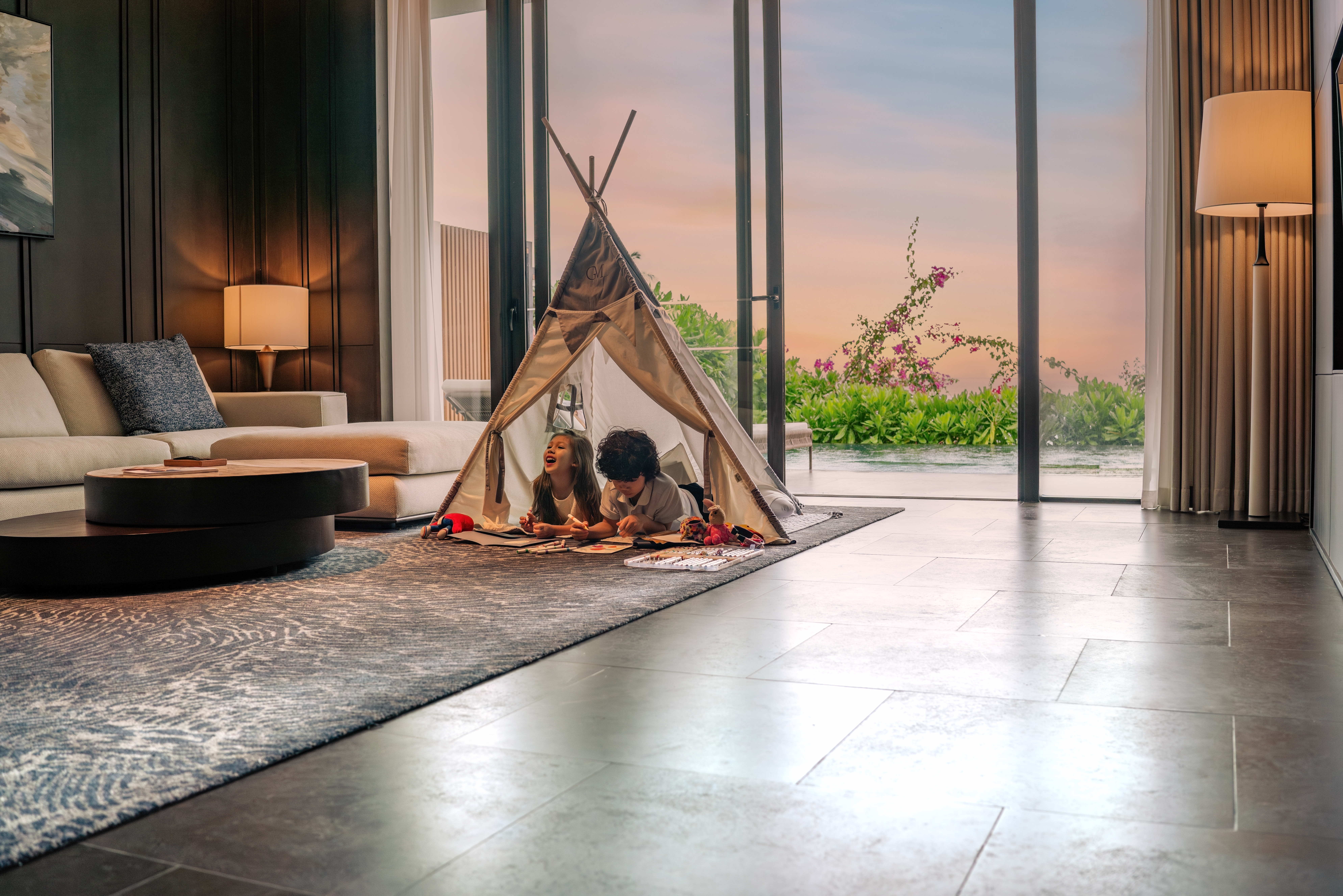 a kids lying in a tent in a living room