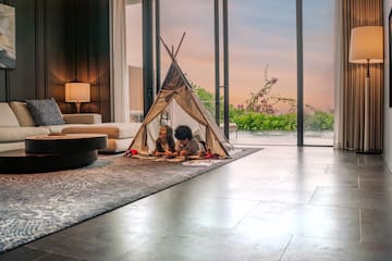a kids lying in a tent in a living room