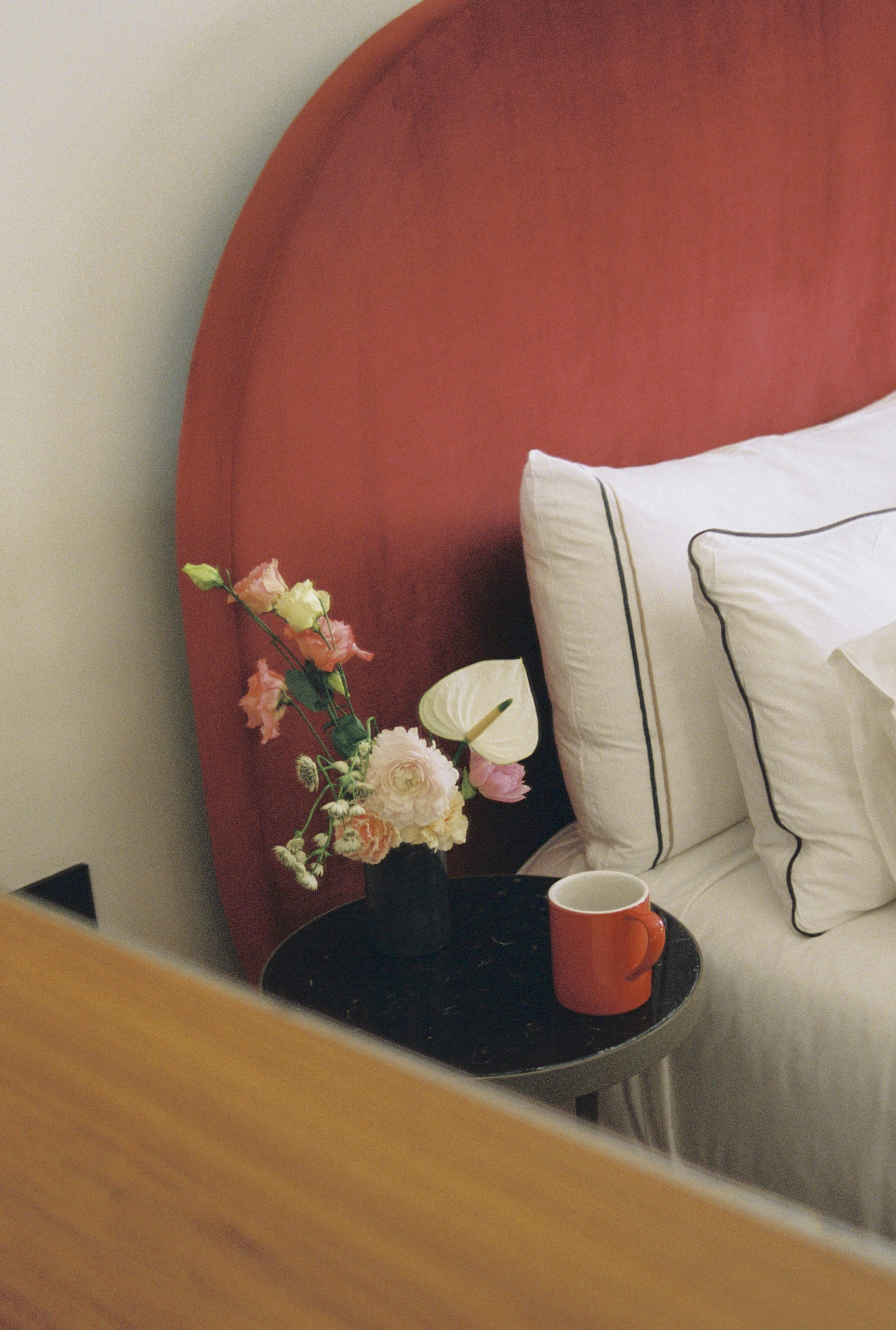 a table with flowers and a cup on it