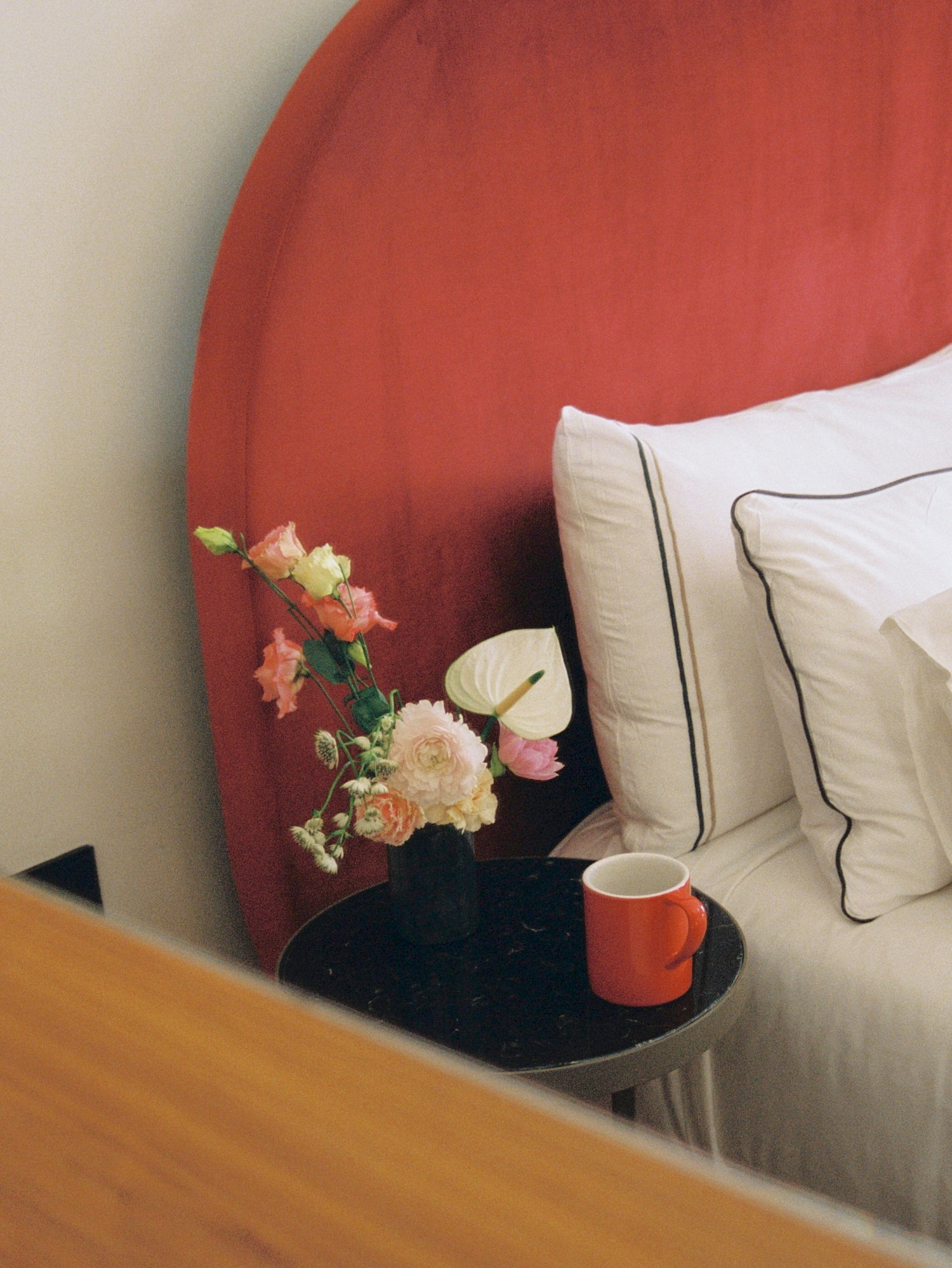 a table with flowers and a cup on it