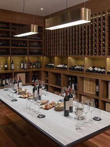 a wine cellar with wine bottles and wine glasses