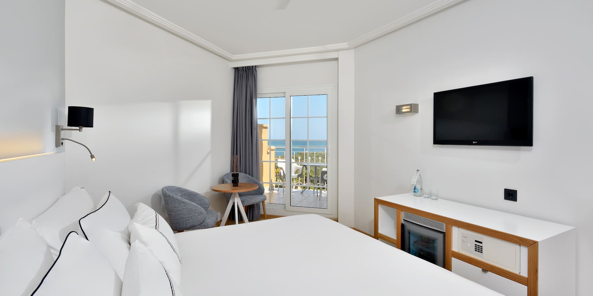 a room with a bed and a television