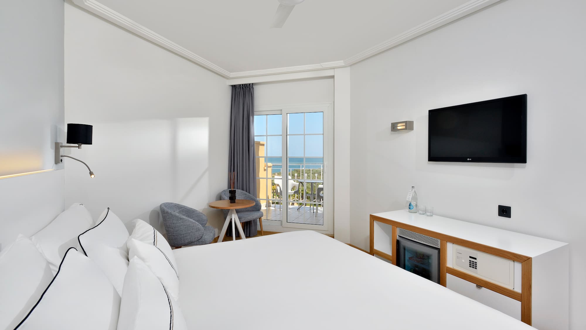 a room with a bed and a television