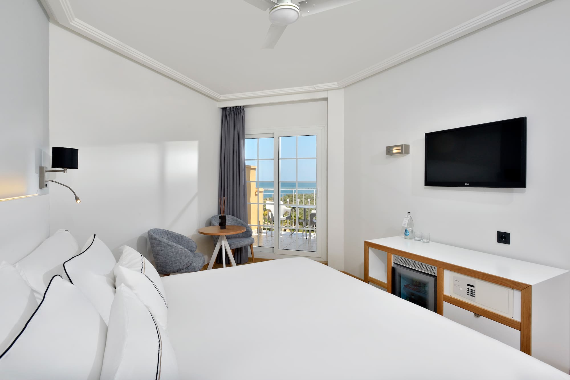 a room with a bed and a television