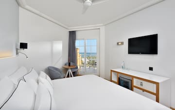a room with a bed and a television
