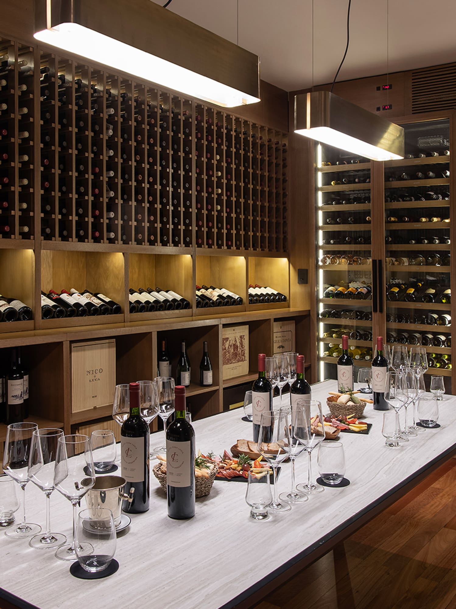 a wine cellar with wine bottles and glasses