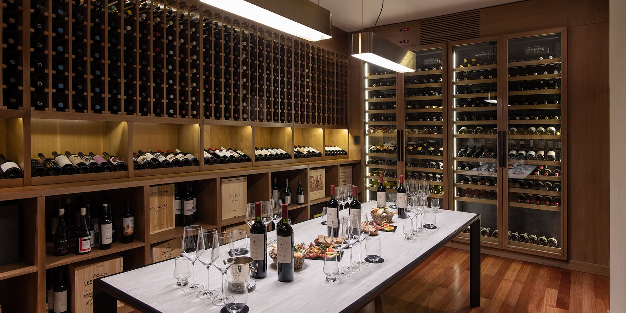 a wine cellar with wine bottles and glasses
