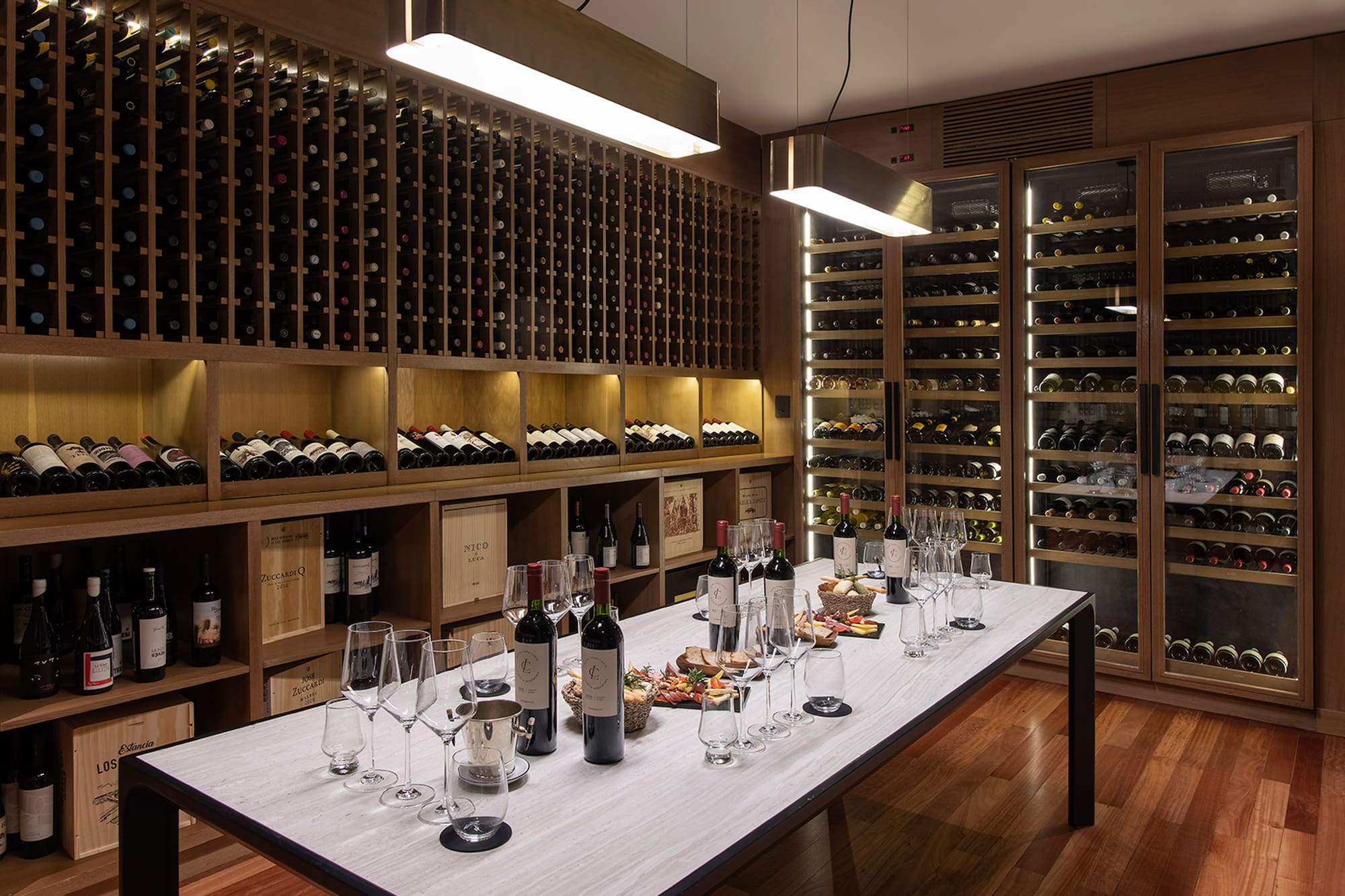 a wine cellar with wine bottles and glasses